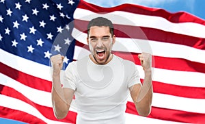 Angry man showing fists over american flag