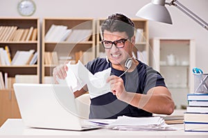 The angry man tearing apart his paperwork due to stress