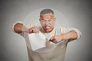 Angry man tearing document to pieces isolated on grey background