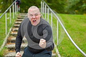 Angry man threatening the camera with his fist