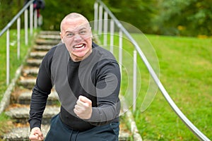 Angry man threatening the camera with his fist