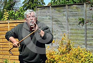 Angry exasperated man with a walking stick. photo