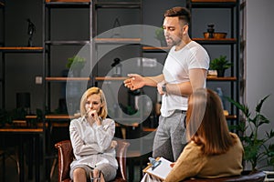 Angry man and woman in psychologist office