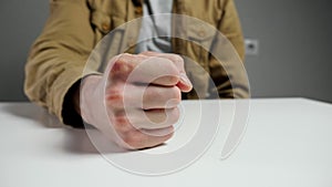 Angry man worker hits table with fist sitting in office