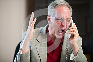 Angry man yelling on the phone