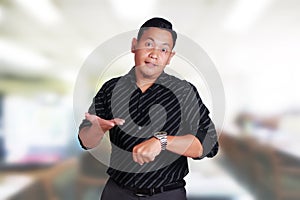 Angry manager businessman while pointing his watch showing time
