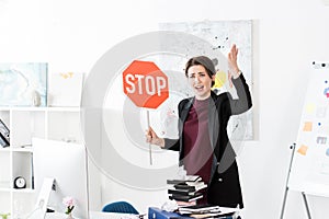 Angry manager holding stop sign and screaming