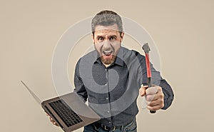 angry manager. professional network administrator hold computer.