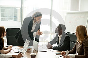 Angry mean boss scolding employee for bad work at meeting