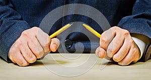 Angry men breaking a pencil