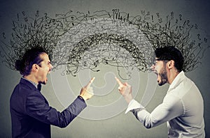 Angry men screaming at each other exchanging with negative thoughts photo