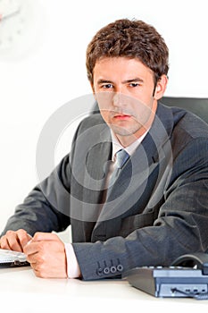 Angry modern businessman banging fist on table