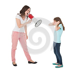 Angry mother shouting through megaphone at daughter