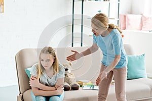 angry mother yelling at teen daughter photo