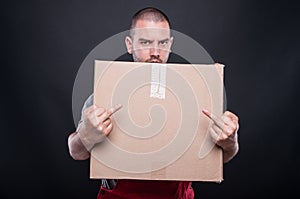 Angry mover man holding box showing double obscene gesture