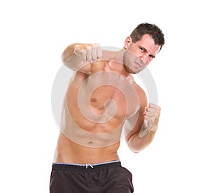 Angry muscular sports man punching