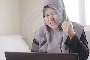 Angry Muslim Businesswoman Working on Laptop, Bad Economic Concept