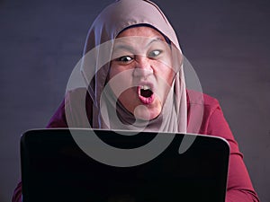 Angry Muslim Businesswoman Working on Laptop at the Office