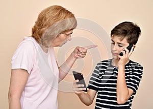 Mother scolding her son with two smarthphones