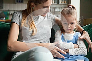 Angry offended little girl ignoring mother words, advice photo