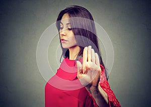 Angry offended young woman giving talk to hand gesture