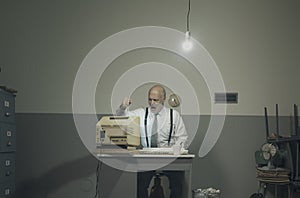 Angry office worker hitting his outdated computer