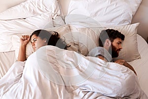 Angry people, couple and fight in bed in the morning feeling frustrated from divorce talk. Marriage problem, conflict