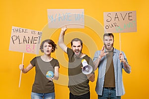 Angry protesting people hold protest signs broadsheet placard world globe scream in megaphone isolated on yellow photo