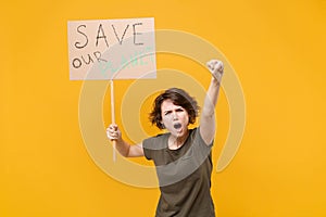 Angry protesting woman hold protest sign broadsheet placard on stick clenching fist screaming isolated on yellow