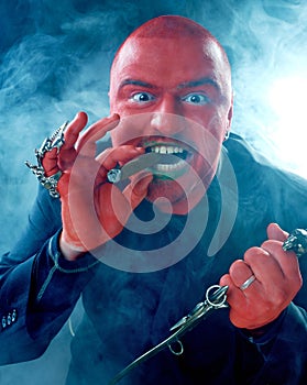 Angry red faced man with knife and cigar