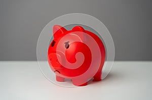 Angry red inflated piggy bank. Inflation is burning savings.