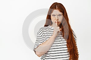 Angry redhead teen girl hush, frowning upset and shushing, tell to be quiet, scolding loud behaviour, warning, showing