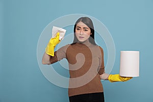 Angry sad and depressed asian houseworker holding tissue paper