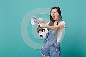 Angry screaming girl football fan support favorite team with soccer ball megaphone pointing finger aside isolated on