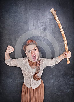 Angry screaming teacher with wooden stick
