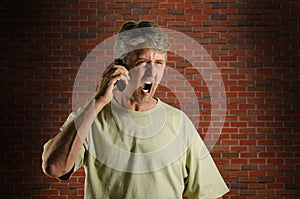 Angry screaming yelling man on a cell phone