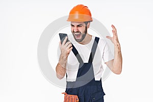 Angry screaming young man using mobile phone