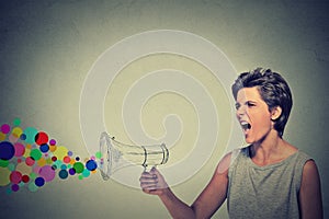 Angry screaming young woman holding megaphone