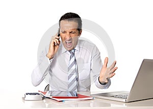 Angry senior businessman in stress working and talking on mobile phone angry