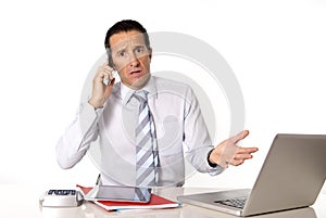 Angry senior businessman in stress working and talking on mobile phone desperate and worried