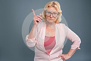 Angry senior woman being about to scold someone