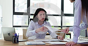 Angry seo businessman at workplace tearing business report documents from manager