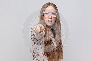 Angry serious woman in glasses looking and pointing finger at camera, suspecting you.