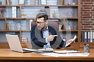 Angry shouting boss talking on video call with colleagues subordinates, man showing laptop document unsatisfactory