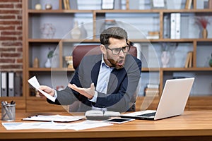 Angry shouting boss talking on video call with colleagues subordinates, man showing laptop document unsatisfactory