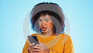 Angry, smartphone and black woman shouting, stress and social media with girl against a blue studio background. African