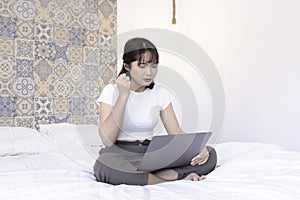 Angry and Stress asian beautiful girl work the laptop in the bed. Work from home concept