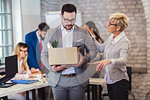 Angry strict dissatisfied female boss firing male incompetent employee