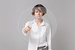 Angry strict young business woman in white shirt posing isolated on grey background studio portrait. Achievement career