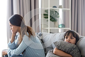 Angry sulky child and annoyed mother not talking after fight